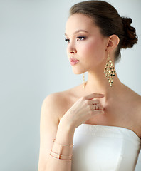 Image showing beautiful asian woman with earrings and bracelet