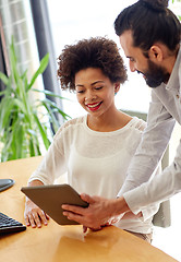 Image showing happy creative team with tablet pc in office