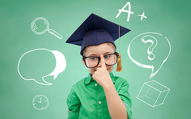 Image showing boy in bachelor hat and eyeglasses over blackboard