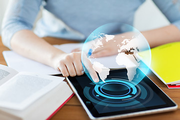 Image showing close up of student with earth globe on tablet pc