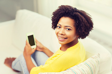 Image showing happy african woman with smartphone at home