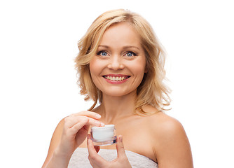Image showing happy woman with cream jar
