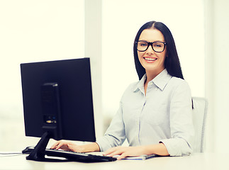Image showing smiling businesswoman or student with eyeglasses