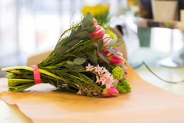 Image showing close up of bunch on paper at flower shop