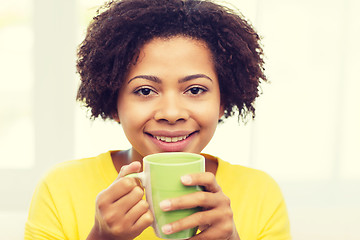 Image showing happy african american woman drinking from tea cup