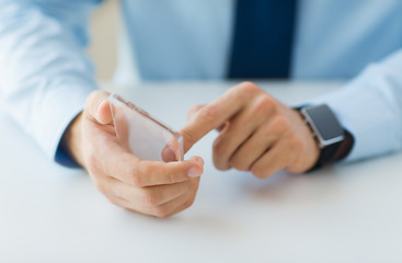 Image showing close up of hands with smart phone and watch