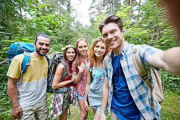 Image showing friends with backpack taking selfie in wood