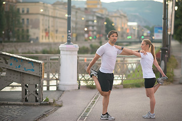 Image showing couple warming up before jogging