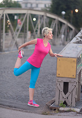 Image showing blonde woman  stretching before morning jogging