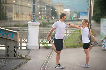 Image showing couple warming up before jogging