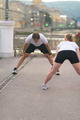 Image showing couple warming up before jogging