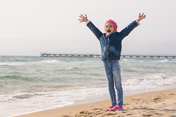 Image showing Seven-year girl rejoices arrival of the sea