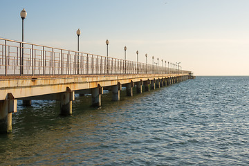 Image showing View of the sea pier stretching into the distance at sunset