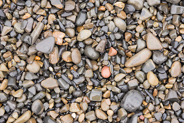 Image showing The surface texture of wet sea beach pebbles of medium and small size