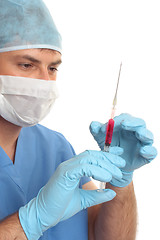 Image showing Surgeon preparing checking needle syringe