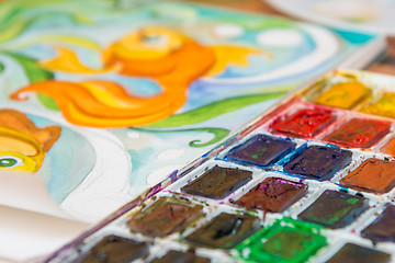 Image showing Close-up of watercolors and a fragment of the picture goldfish