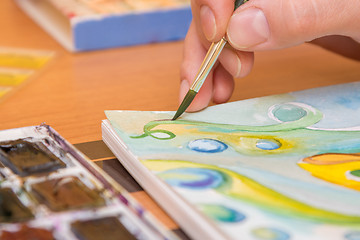 Image showing Close-up of the process of drawing watercolor on paper