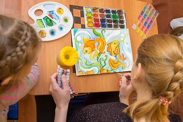 Image showing Teaching a child watercolor drawing top view