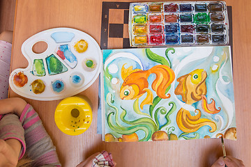 Image showing Top view on a table behind which painted watercolor on paper goldfish