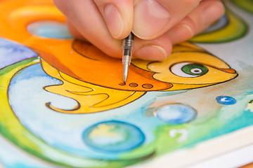 Image showing Close-up of the process of drawing goldfish