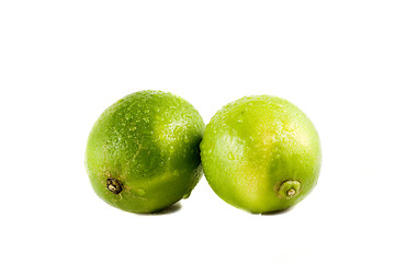 Image showing Lime fruits with water drops isolated on white background