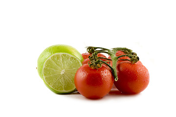 Image showing Two limes and two tomatos isolated on white background