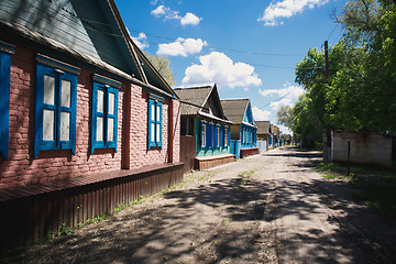 Image showing one-storey houses stand along the road in the village