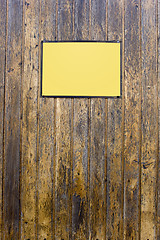 Image showing Grungy wood texture with a yellow sign for background