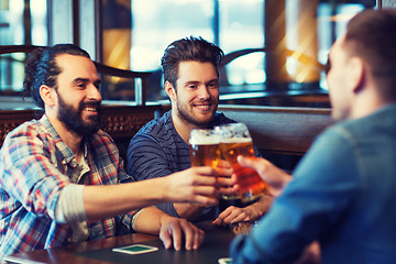 Image showing happy male friends drinking beer at bar or pub