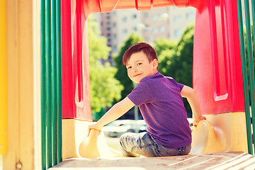 Image showing happy little boy on slide at children playground