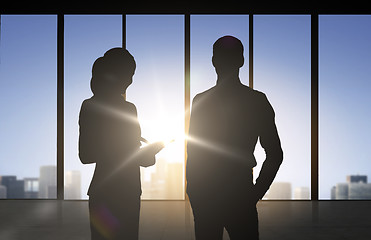 Image showing silhouettes of business partners over office