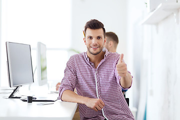 Image showing happy creative man with computer at office