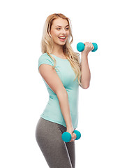 Image showing happy beautiful young sporty woman with dumbbells