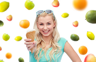 Image showing happy young woman in sunglasses eating ice cream