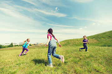 Image showing group of happy kids running outdoors