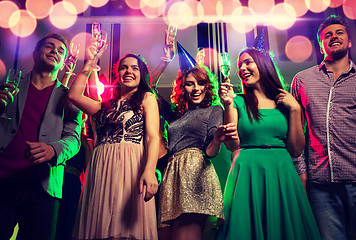 Image showing smiling friends with glasses of champagne in club