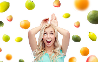 Image showing happy smiling young woman making bunny ears