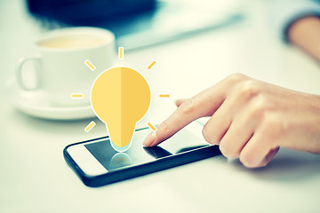 Image showing close up of woman hand with smartphone and coffee