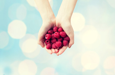 Image showing close up of woman hands holding raspberries