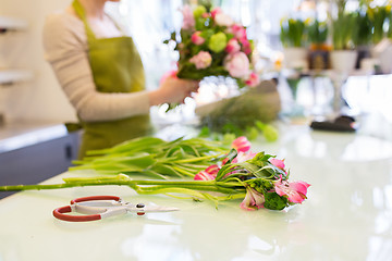 Image showing close up of woman making bunch at flower shop