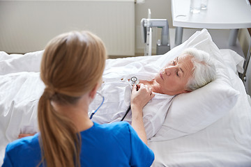 Image showing nurse with stethoscope and senior woman at clinic