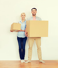 Image showing couple with cardboard boxes moving to new home