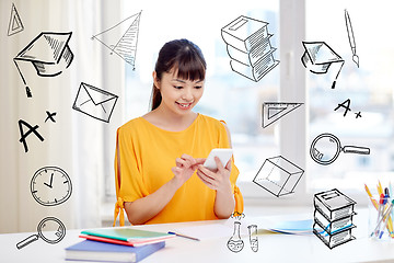 Image showing happy young woman student with smartphone at home