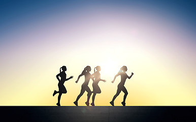 Image showing happy young sports woman running outdoors