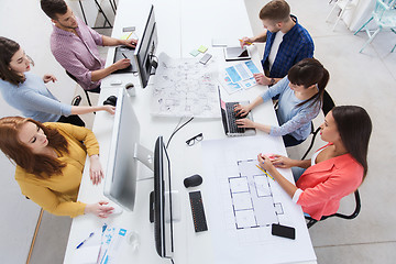 Image showing creative team with computers, blueprint at office