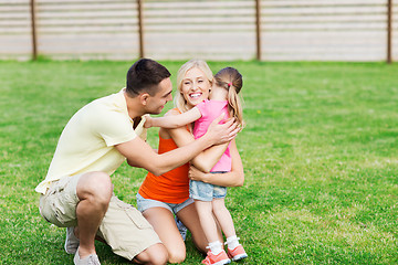 Image showing happy family hugging outdoors