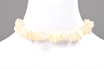 Image showing Splintered orange calcite chain on bust