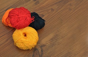 Image showing Balls of wool on wood