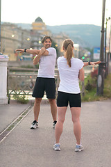 Image showing couple warming up before jogging