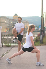 Image showing couple warming up before jogging